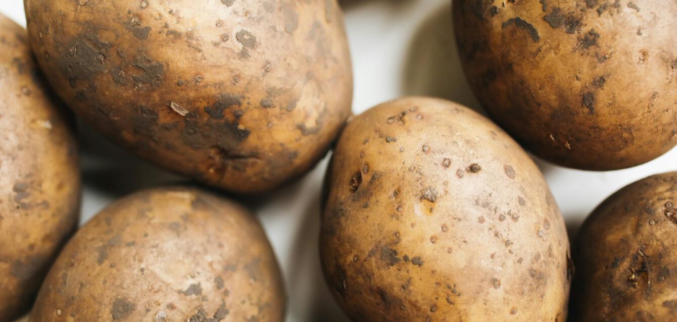 Photo by Polina Tankilevitch A close-up view of freshly harvested potatoes showcasing their natural texture and rustic appearance.