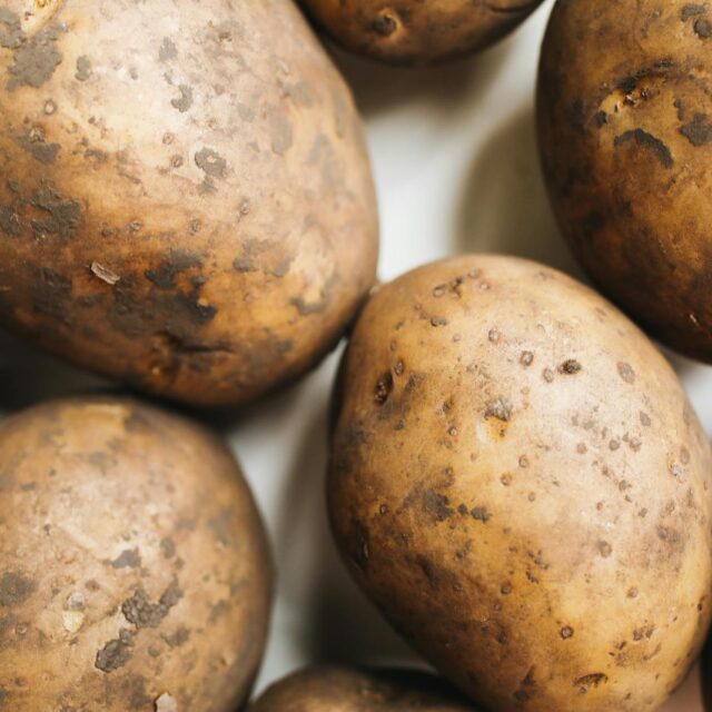 A close-up view of freshly harvested potatoes showcasing their natural texture and rustic appearance.