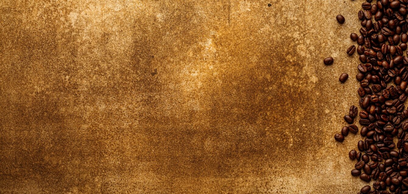 Photo by Sergey Kotenev a grungy background with coffee beans on it