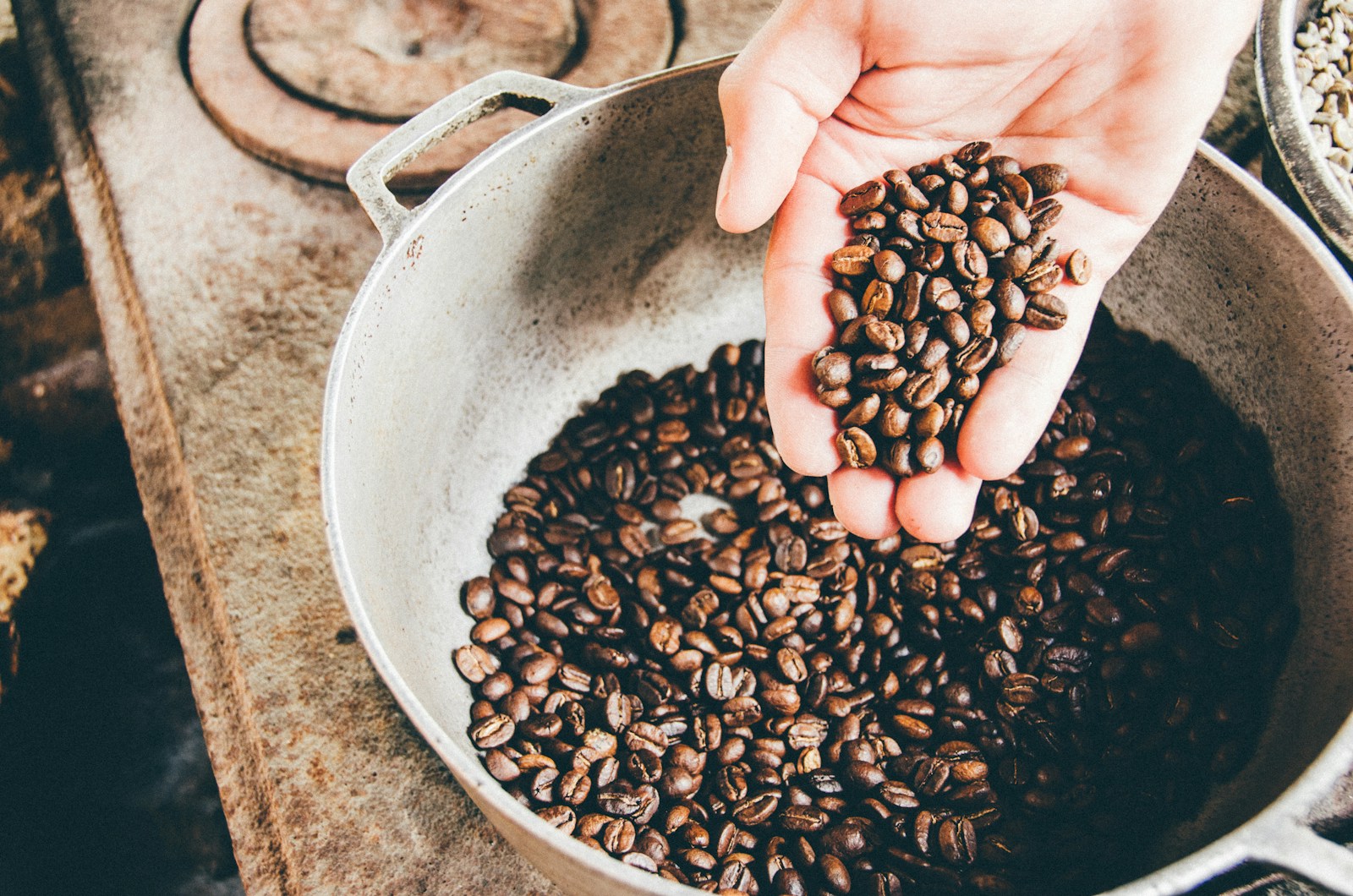 Photo by Milo Miloezger coffee beans on gray steel wok